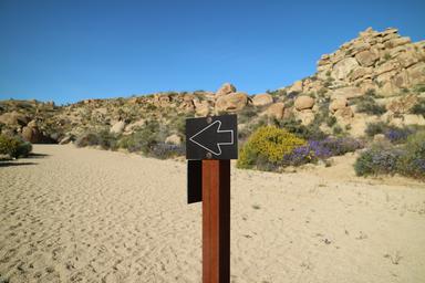 a sign on a post in the desert